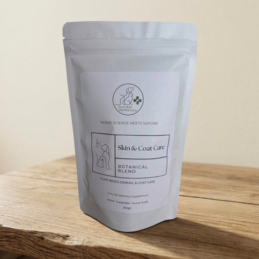 A white stand-up pouch of 'Natural Remedies' Skin & Coat Care Botanical Blend pet supplement, displayed on a wooden surface against a neutral beige background.